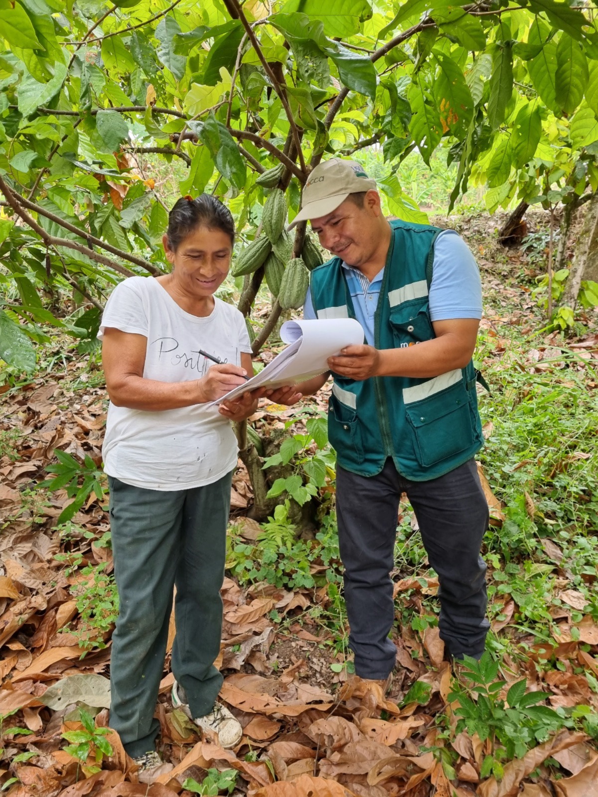 A representative from LWR’s partner organization Mocca liaises with a smallholder cacao farmer